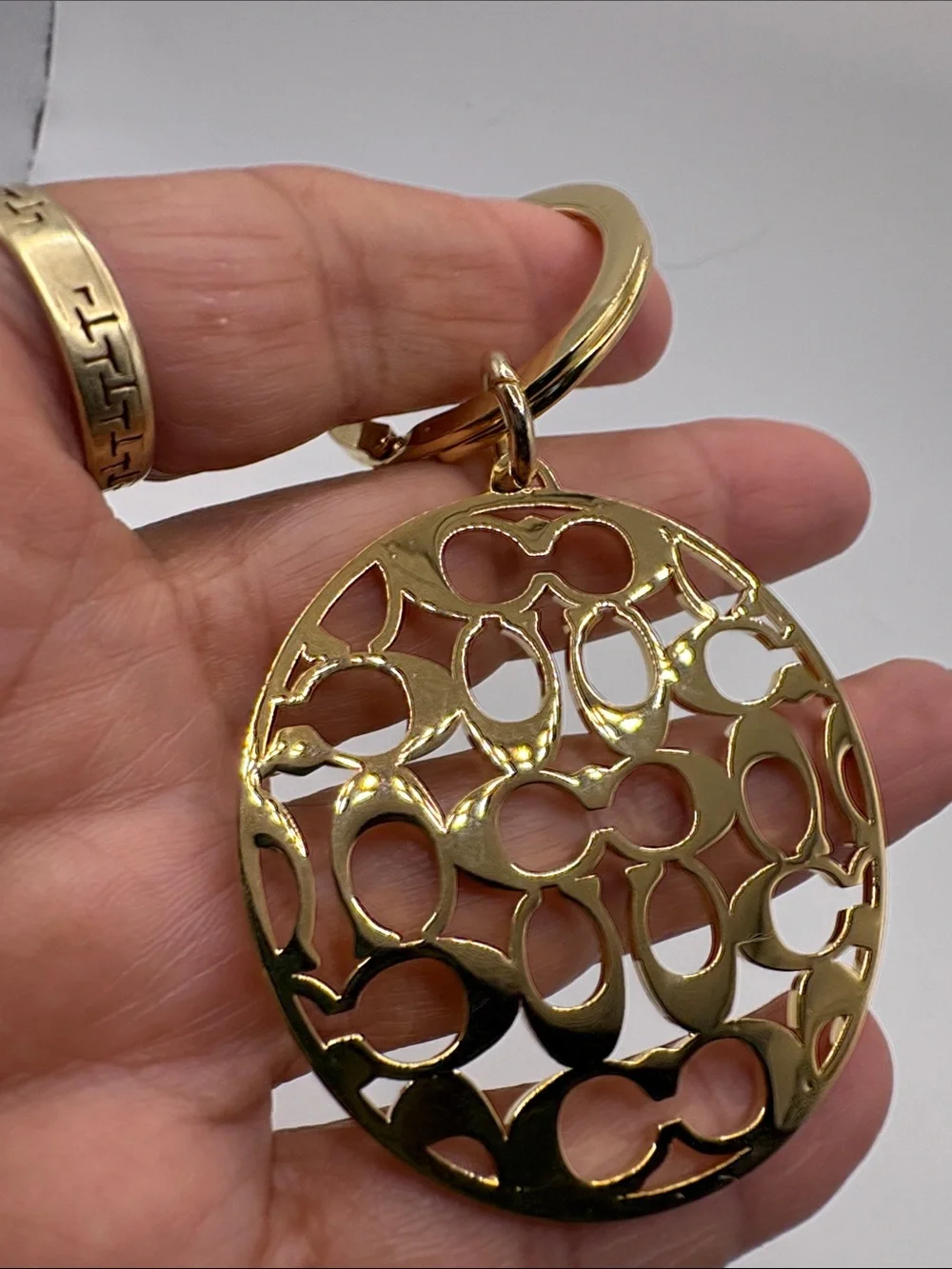 Coach Gold Logo Cutout Circle Keychain
